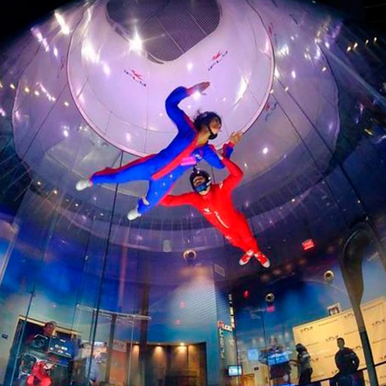 Indoor skydiver flying with an instructor at iFLY Houston Woodlands