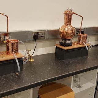 Distill a bottle of gin on mini copper stills 2