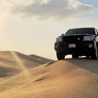 Sunset Desert Safari mit Quad, Sandboarding, Kamelritt + BBQ-Dinner 9