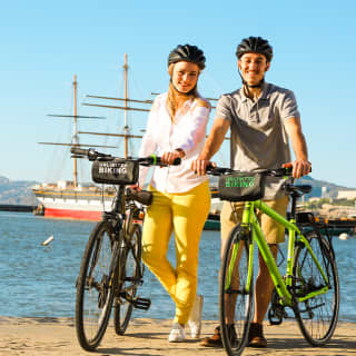 Cover footage from Fever, of a couple wearing helmets and standing by their bikes. Hop on a Bike and Explore the City of San Diego Today!